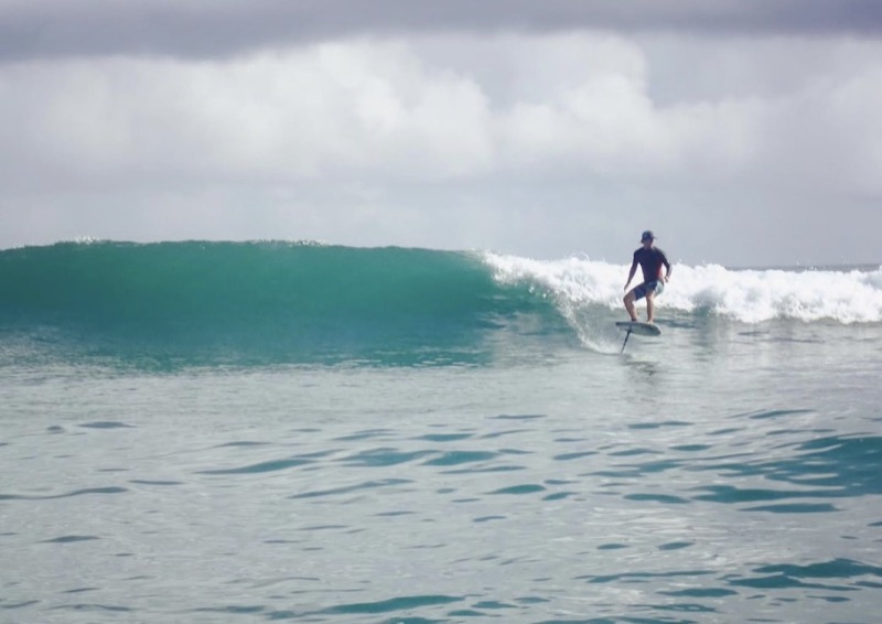 Surf foiling on a wave