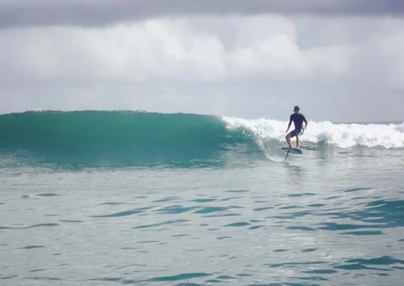 Surf foiling on a wave